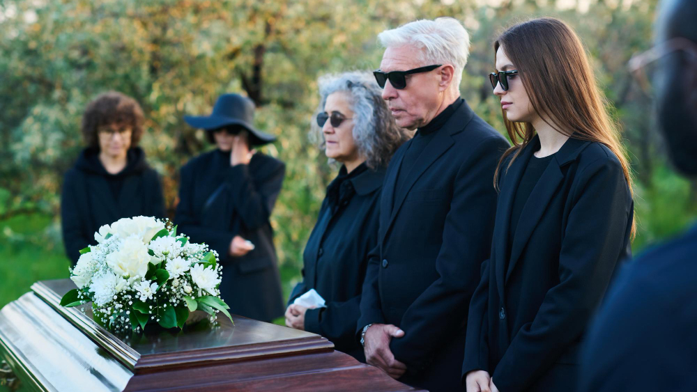 a funeral with family standing around the casket after a wrongful death accident