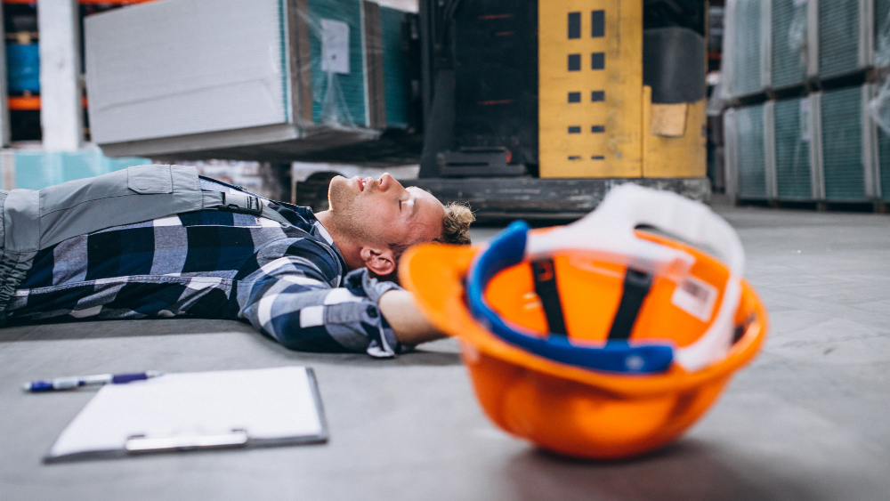 a man lying unconscious on the floor in a construction accident, construction accidents